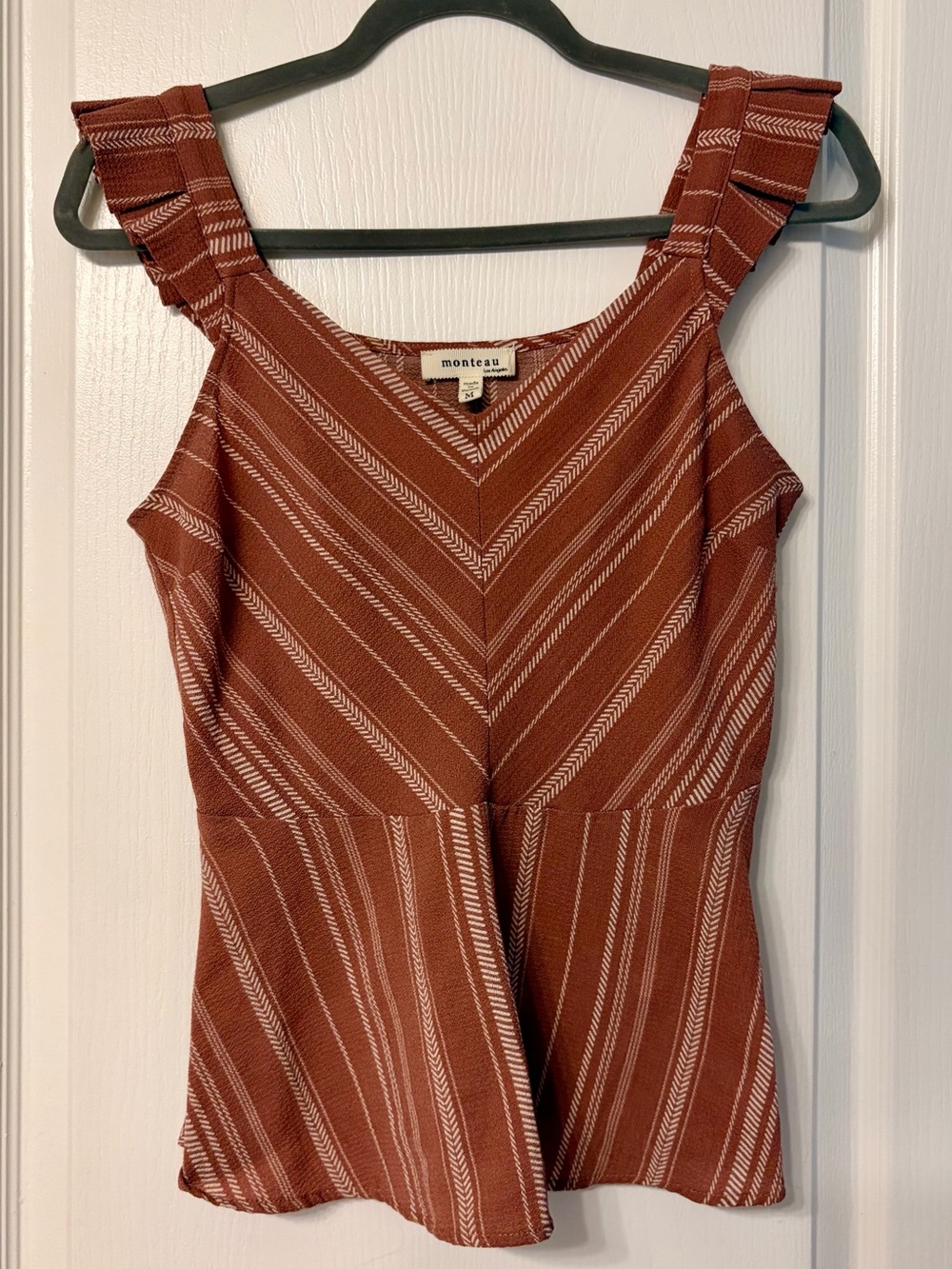 Women’s sleeveless top with ruffle straps and flare waist